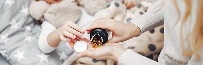 Mother giving her daughter medication